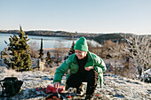 Woman preparing food outdoors at winter