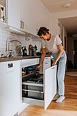 Woman putting waste in bin