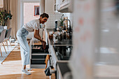 Smiling woman in kitchen looking away