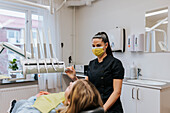 Female dentist with patient in dentist's office