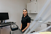 Female dentist sitting in office
