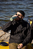 Man relaxing and having drink at sea