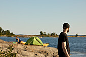 Side view of man standing at sea