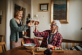 Senior couple raising toast at home