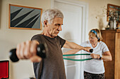 Senior couple exercising at home