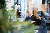 Businesswomen talking in cafe