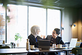 Businesswomen talking in cafe