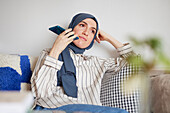 Woman on sofa using cell phone