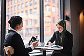 Smiling women sitting in cafe