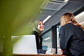 Women sitting together in office