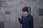 Handsome man with smartphone on street