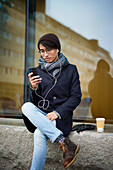 Smiling man using cell phone