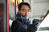 Smiling man holding cell phone