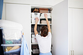 Woman standing in front of open wardrobe