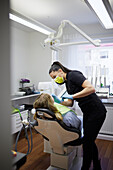 Female dentist with patient in office