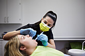 Female dentist with patient in office