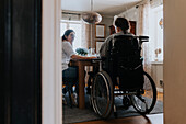 Mother with daughter sitting at table