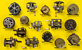 Vintage fishing reels on yellow background