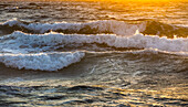 Close-up of sea waves reflecting sunlight