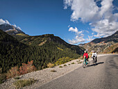 United States, Utah, American Fork, Man and woman riding bicycles on mountain road