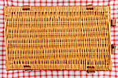 Overhead view of closed wicker picnic basket