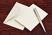 Umschlag und Stift auf Holztisch