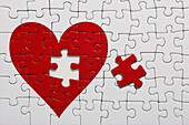 Jigsaw puzzle with red heart