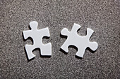 Two white jigsaw pieces