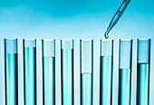 Pipette dropping liquid into test tube