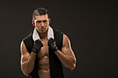 Portrait of muscular man wearing sports gloves