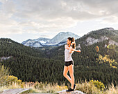 United States, Utah, American Fork, Woman stretching in mountain landscape