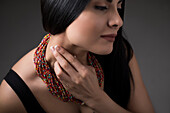 Close-up of woman touching neck