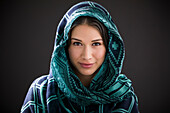 Studio portrait of smiling woman with shawl on head