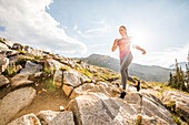 United States, Utah, Alpine, Woman jogging in mountains in summer