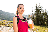 United States, Utah, Alpine, Portrait of female hiker holding drinking bottle