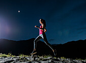 United States, Utah, Alpine, Woman jogging in mountains at night