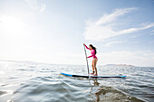 Woman paddleboarding on lake