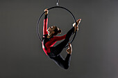 Teenage aerialist (14-15) practising on gymnastic hoop