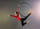 Jugendlicher Luftakrobat (14-15) beim Üben am Gymnastikreifen