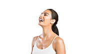 Portrait of young woman laughing against white background