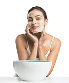 Portrait of young woman enjoying washing face