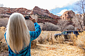 USA, Utah, Escalante, Woman taking photos in Grand Staircase-Escalante National Monument