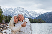 USA, Idaho, Stanley, Portrait of smiling senior couple at mountain lake