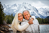 USA, Idaho, Stanley, Portrait of smiling senior couple at mountain lake