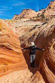 United States, Utah, Escalante, Senior hiker exploring slot canyon