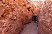 United States, Utah, Escalante, Senior hiker exploring slot canyon