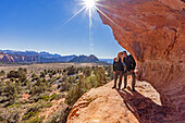 United States, Utah, Zion National Park, Senior couple standing on sandstone cliff