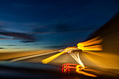 Blurred image of lights on highway at dusk