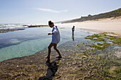 South Africa, Western Cape, Boy (8-9) and girl (16-17) exploring tidal pools in Lekkerwater Nature Reserve
