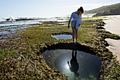 South Africa, Western Cape, Girl (16-17) exploring tidal pools in Lekkerwater Nature Reserve